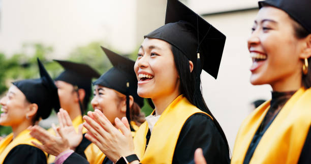 istock Excited, clapping and graduation for group, education and  success for students, happy and achievement. College, accomplishment and applause for knowledge, friends and Asian people on event in Japan 2188173826