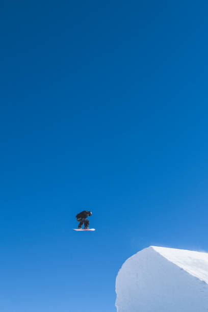 istock Snowboarder gets air off of jump 2188175232