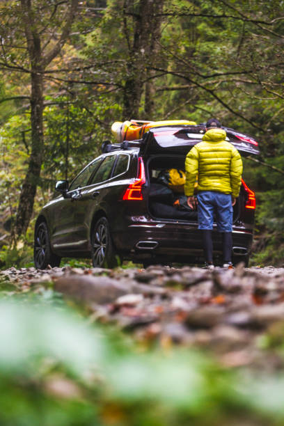 istock Kayaker loads SUV with sports equipment 2188175407