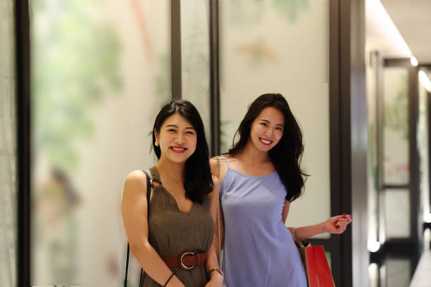 istock Beautiful young ladies enjoying shopping 2188177717