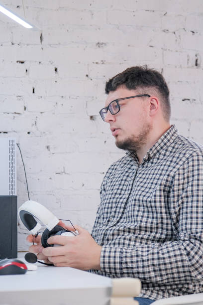 istock Man Working from Home on Laptop Computer in Stylish Loft Apartment 2188179629