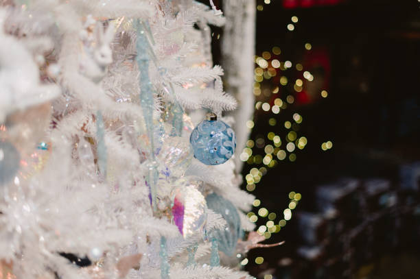 istock A white Christmas tree with many decorations including a bell 2188180019