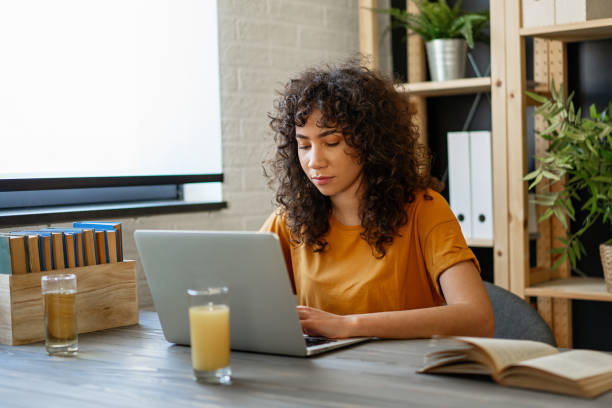 istock Young beautiful student girl working, learning in college library 2188180040