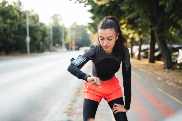 istock Exercising woman checks progress in bright workout gear. 2188180411