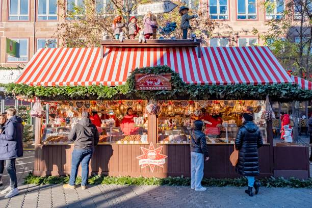 11/29/2024, Nuremberg, Germany. People shopping at the Christmas stalls at the world famous Christmas market in Nuremberg.