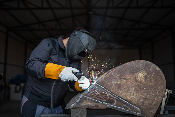 istock Professional welder working on metal construction in industrial workshop 2188187550
