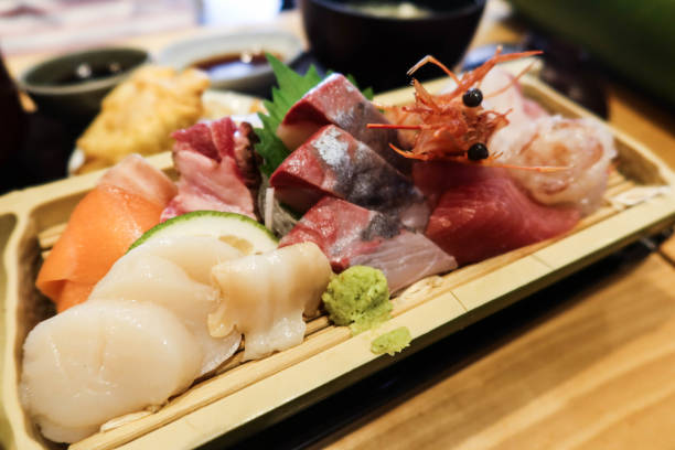istock Japanese assorted sashimi including prawns, shrimps, fish, salmon, snapper and flounder fish slice on a wooden plate 2188188081