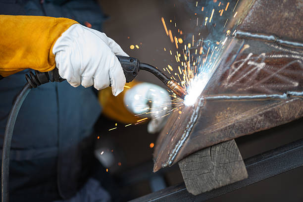 istock Welder joining metal parts with welding torch creating sparks 2188189176