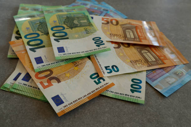 istock Various other colorful euro banknotes are scattered on the table, symbolizing savings or budgeting. 2188189210