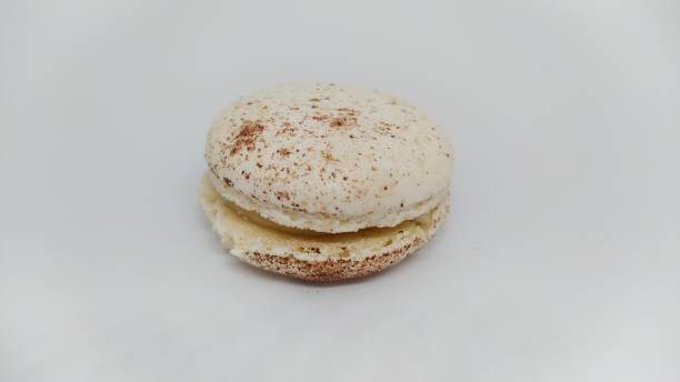 Indulge in a delicious Almond Macaron, expertly crafted with a creamy and delightful filling