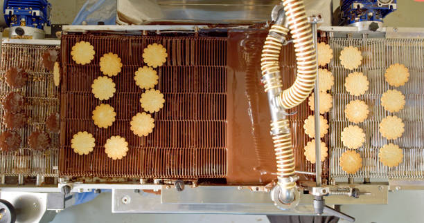 istock Cookies on conveyor belt being dipped in chocolate 2188189997
