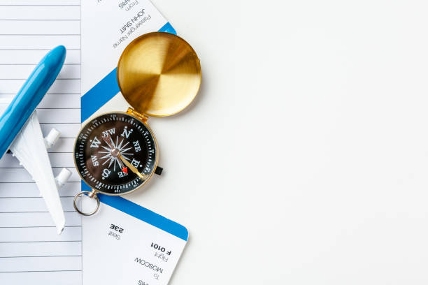 istock Flight tickets and compass isolated on white background close up 2188190224