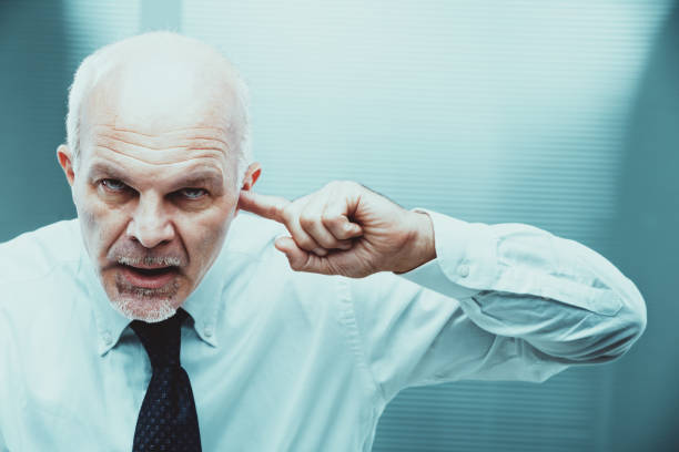 istock Angry senior manager covering ears and shouting at work 2188192680