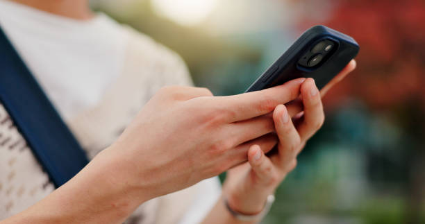 istock Phone, hands and student in city for email typing for communication, networking or contact. Closeup, cellphone and person with mobile app for university test results online outdoor in town 2188192921
