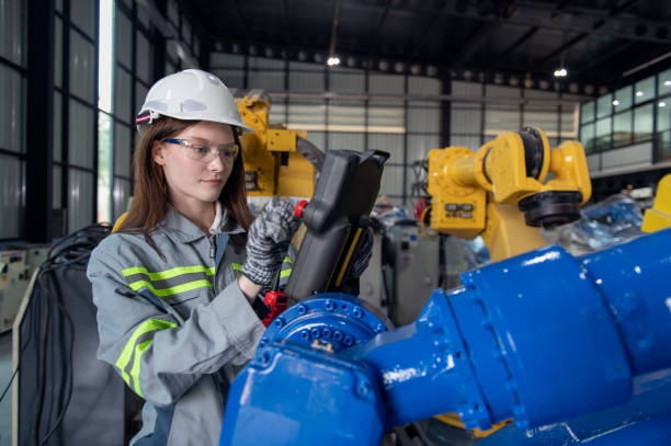 istock Engineer standing by robotic arm and operating machine in industry factory, technician worker check for repair maintenance electronic operation 2188197131