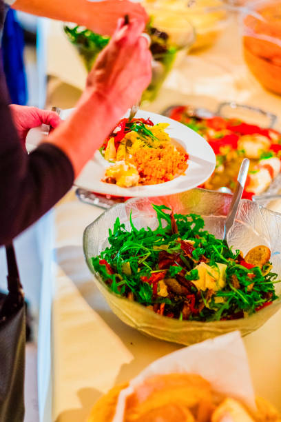 Colorful Plate of Fresh Vegan Salad and Couscous Served at a Buffet Table with a Variety of Healthy Ingredients, Showcasing a Delicious and Inviting Meal Option Perfect for Any Dining Occasion