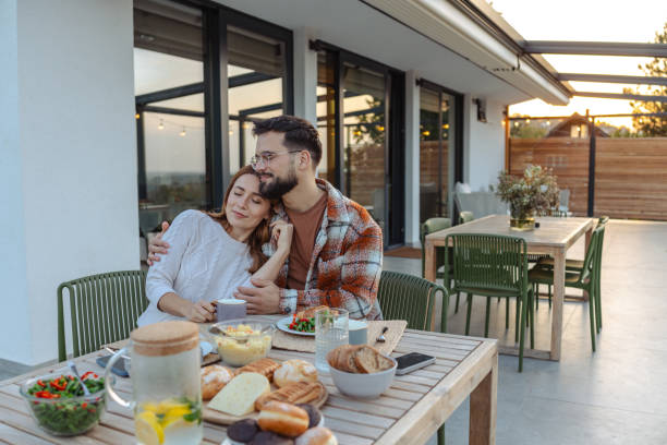 istock Romantic couple enjoying breakfast together on a sunny patio 2188198573