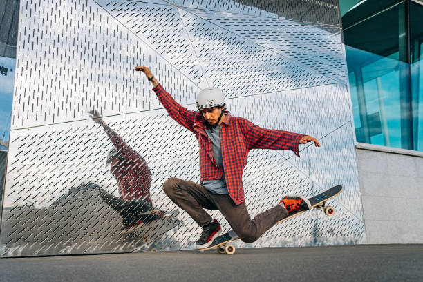 istock Skateboarder balancing on skateboard in front of modern building 2188198698