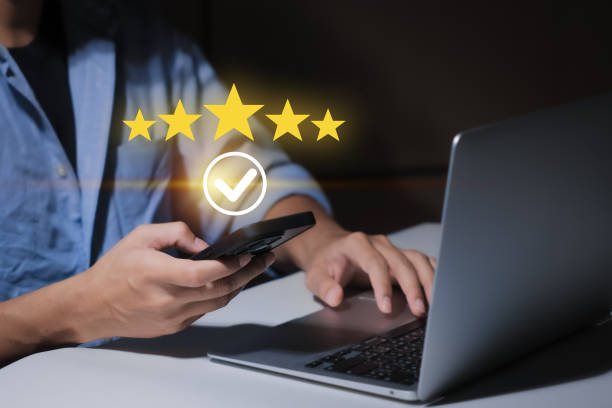 istock close up Man hand using smartphone with popup five star icon for feedback review satisfaction service, Customer service experience and business satisfaction survey. 2188198738