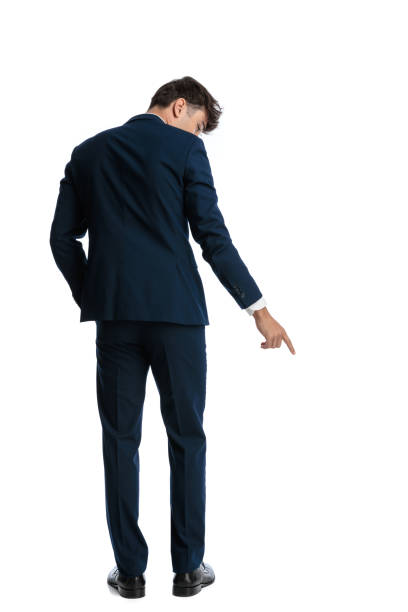 istock back view of elegant man pointing finger on the floor 2188202059