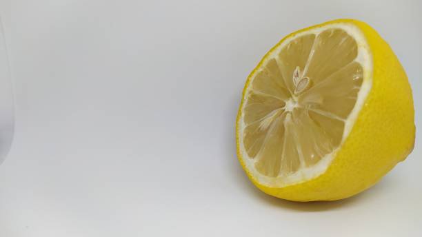 istock A Fresh Lemon Half Displayed on a Vibrant White Background, Ideal for Culinary Use 2188203607