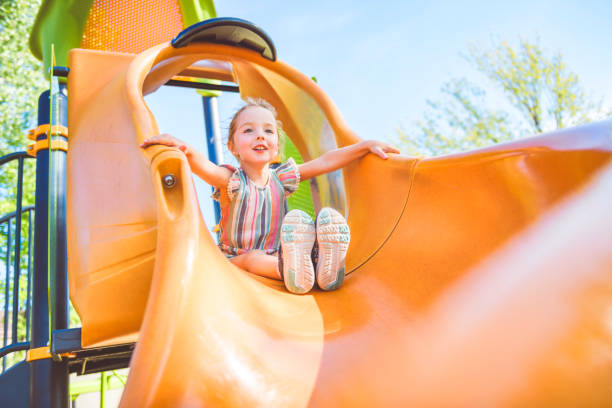 istock Happy kid slide on playground on summer season 2188204627