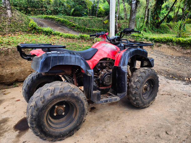 istock Red ATV Parked on Dusty Trail in Lush Forest Setting 2188205684