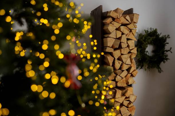 istock Cozy holiday scene with firewood and bokeh lights. 2188207485