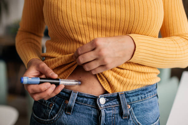 Woman Injecting IVF Medication into Stomach