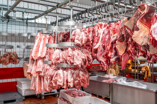 istock Pork and beef hanging in a butcher shop 2188208901