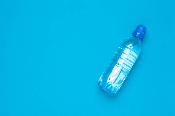 istock plastic water bottles with caps of different colour on the table 2188208980