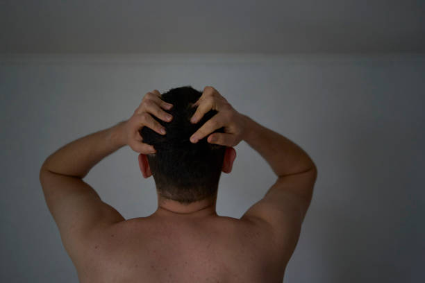 A 30-year-old man is stressed, holding his head with his hands