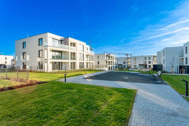 istock Modern residential complex with green areas and construction crane on sunny day 2188209429