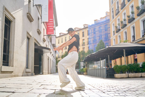 istock Young woman dancing outdoors on a sunny street 2188214381