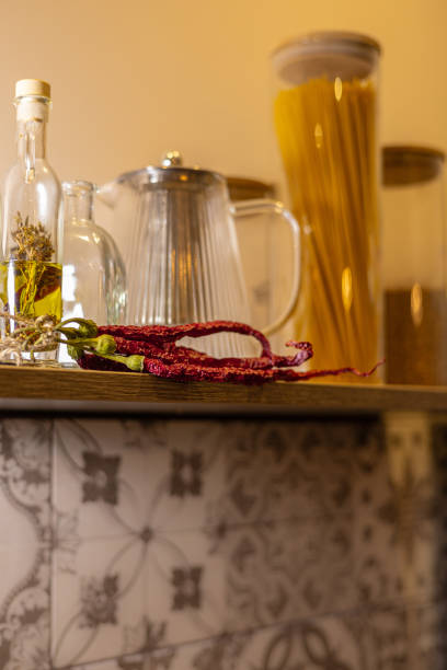 istock Rustic Kitchen Shelf with Dried Chili, Glass Bottles, and Pantry Jars 2188214386