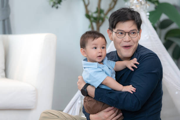 Father and son play together after dad comes home from office