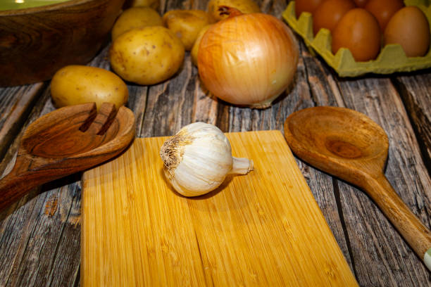 istock Wooden spoons garlic onion potato and eggs placed on table 2188215852