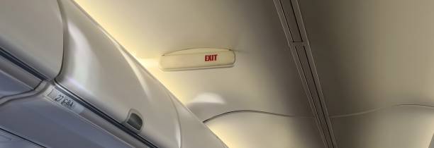 istock Exit sign in modern jet plane. Air travel safety and aircraft exit 2188218336
