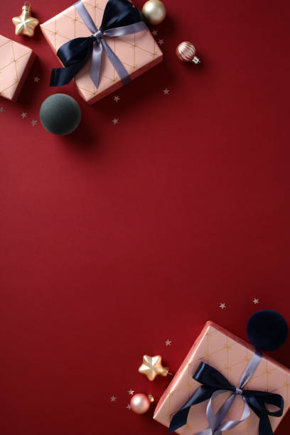 istock Elegant gift boxes with chic ribbons on a rich red background. Flat lay, top view, vertical 2188218421