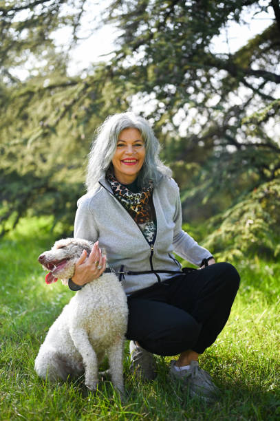 istock Smiling senior woman hugging her Labradoodle dog 2188218448