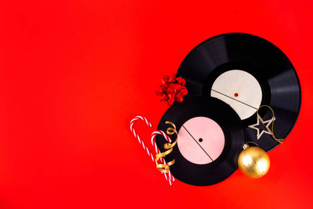 Disc jockey plays music set on New Year's Eve celebration while wearing traditional red Santa Claus costume on stage