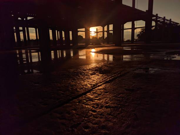 istock A sunset shines through the open windows of an unfinished building. 2188220661