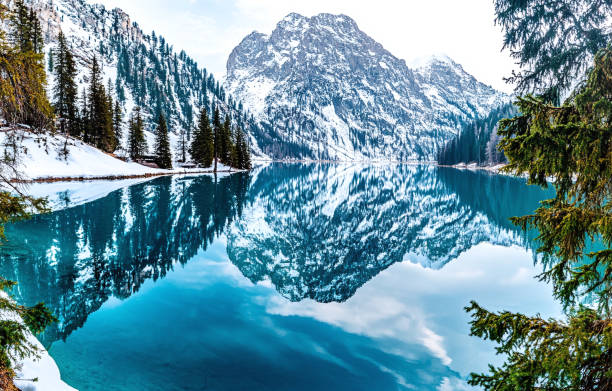 istock Mirror Reflection of Snowy Peaks on a Lake 2188224298