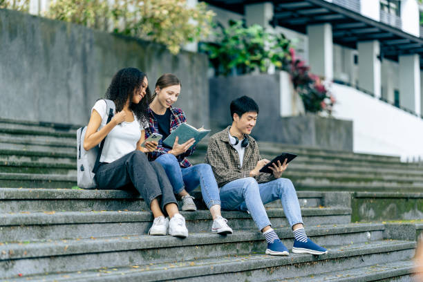 istock educational campus University students holding laptops talk or talk about exams, books, friends or outdoor variety. 2188226522