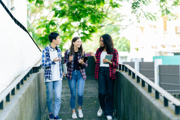 istock educational campus University students holding laptops talk or talk about exams, books, friends or outdoor variety. 2188226653