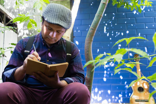 istock a man in poet's clothes writes poetry 2188231655