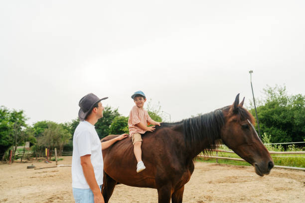 istock Daddy and me at the horse ranch 2188235644