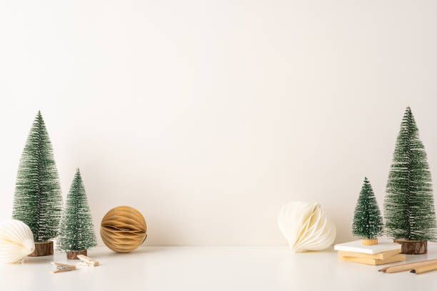 istock Minimalist side view Scandinavian winter decor featuring small Christmas trees and paper decorations. The clean and simple design creates a cozy and elegant atmosphere perfect for the holiday season 2188235976