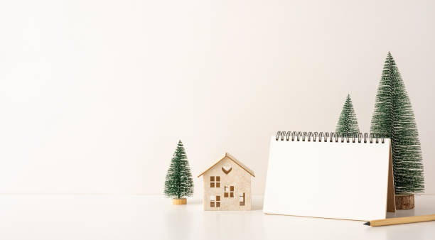 istock A side view minimalist Scandinavian-style desk setup with miniature trees and a blank spiral notebook, creating a cozy winter atmosphere 2188235978