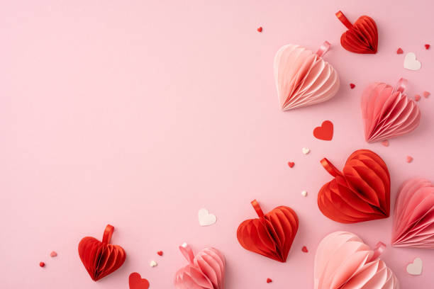 istock Delicate red and pink paper hearts scattered on a soft pink background, creating a romantic and festive atmosphere for Valentine's Day 2188236023